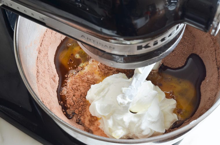 adding eggs, oil, and sour cream