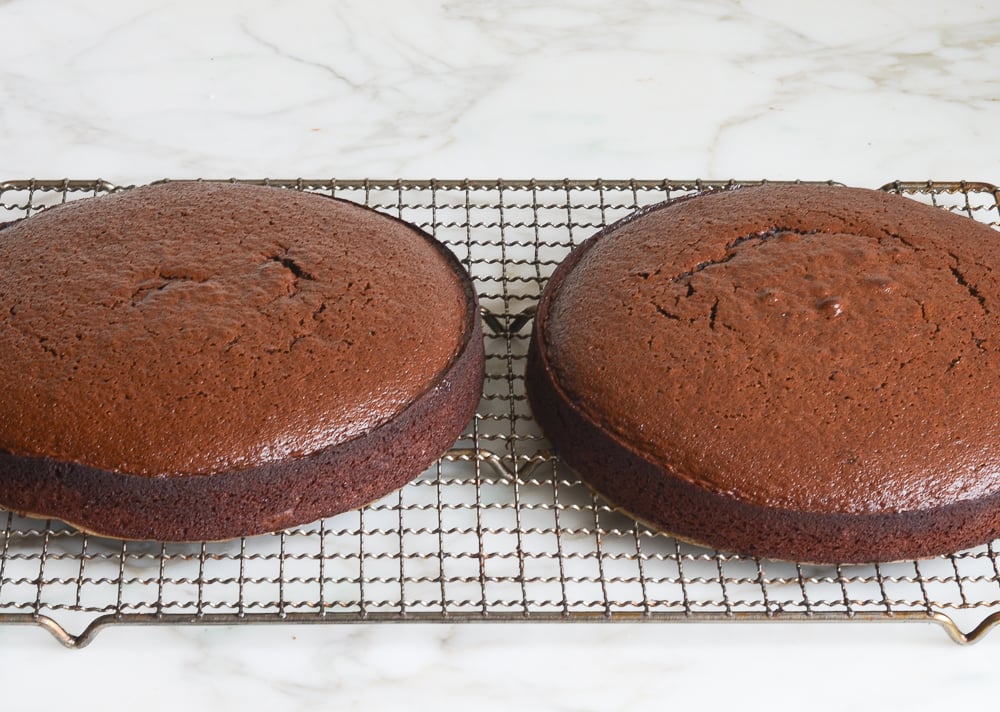 chocolate cake layers cooling on rack.