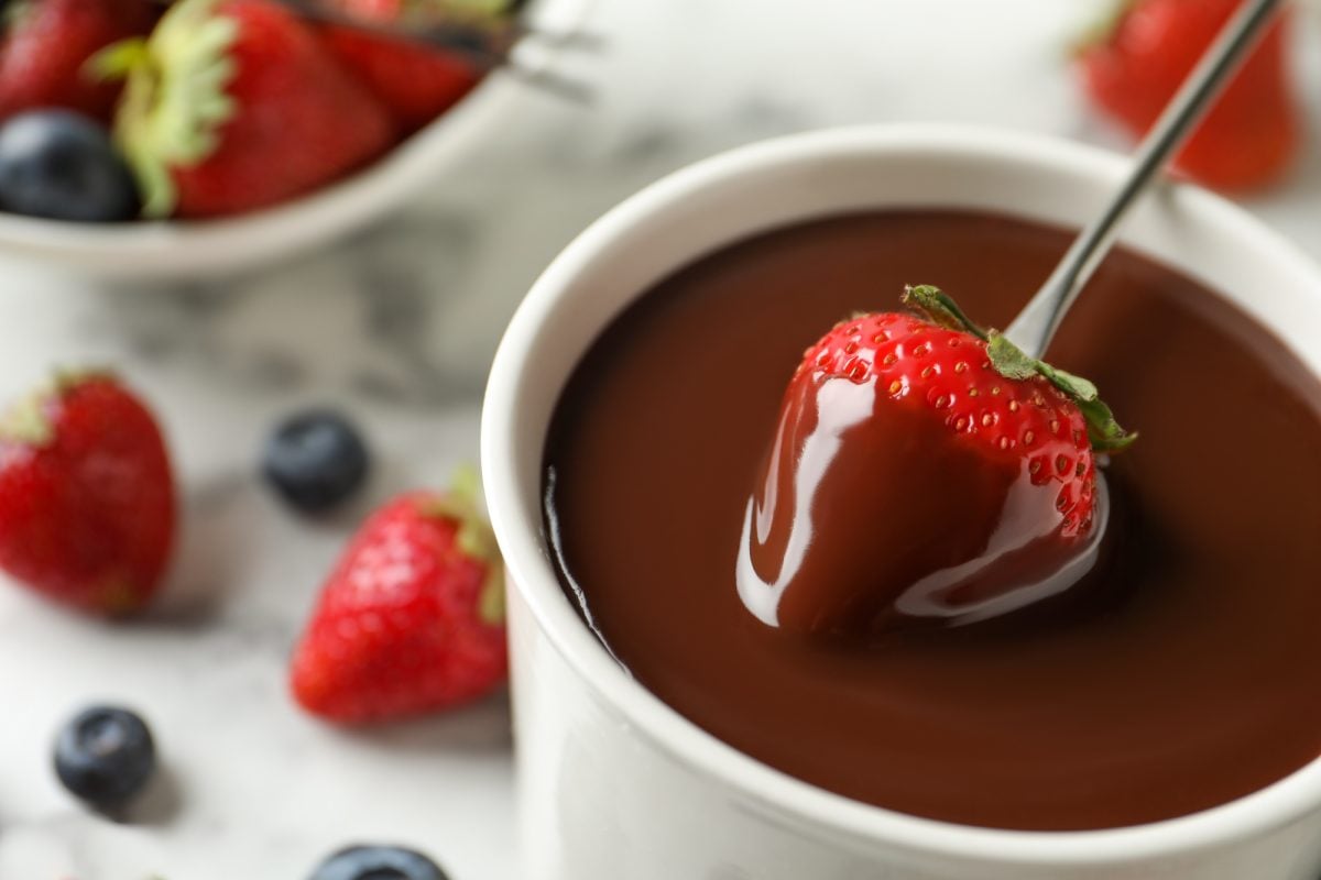 dipping strawberry into chocolate fondue