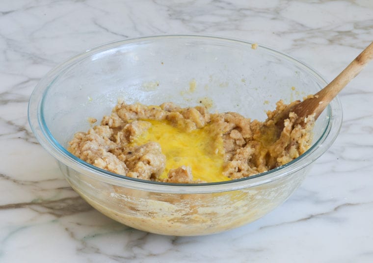 Eggs in a bowl of dough.
