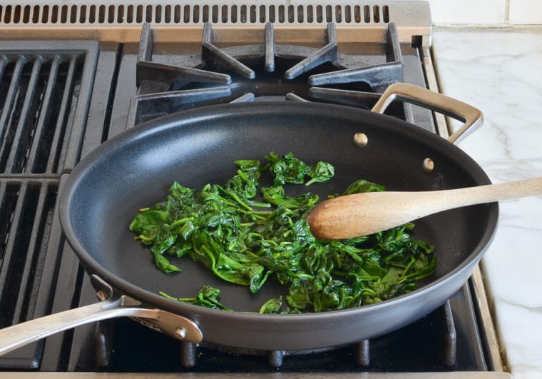 Skillet of wilted spinach.