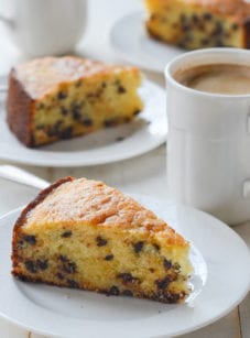 Slices of chocolate chip ricotta cake on small plates.