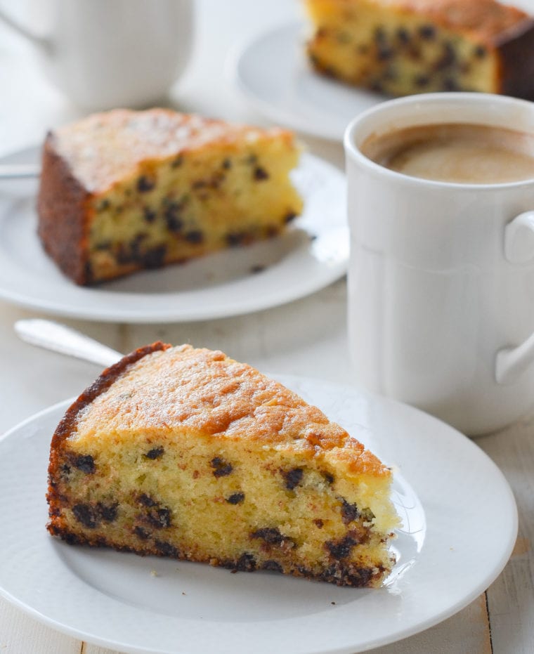 Slices of chocolate chip ricotta cake on small plates.