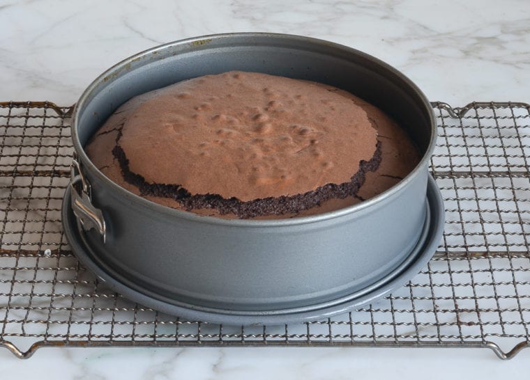 baked flourless chocolate cake on rack
