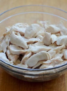 Glass bowl of poached chicken.