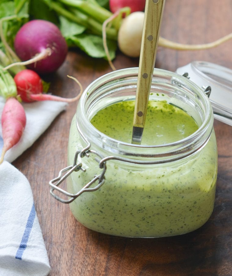 Glass jar of green goddess dressing.