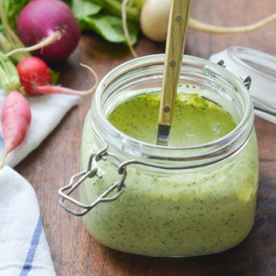 Glass jar of green goddess dressing.
