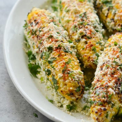Plate of grilled Mexican street corn (elote.)