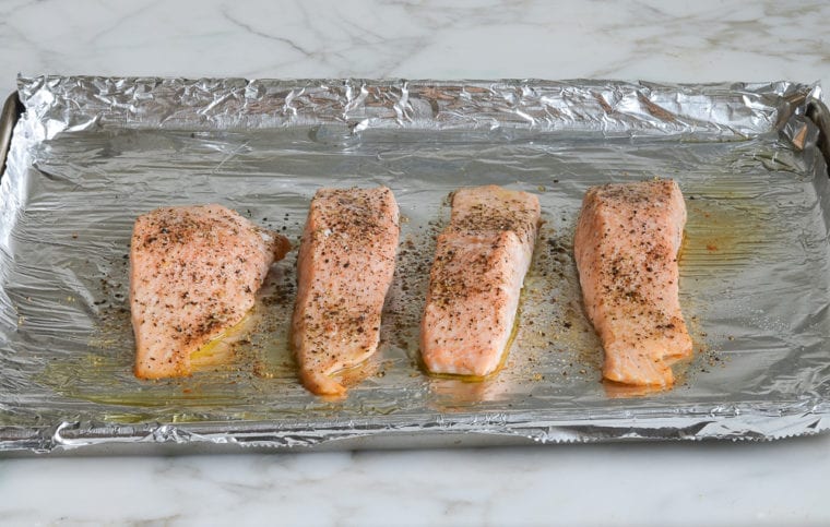 Lined baking sheet of roasted salmon.