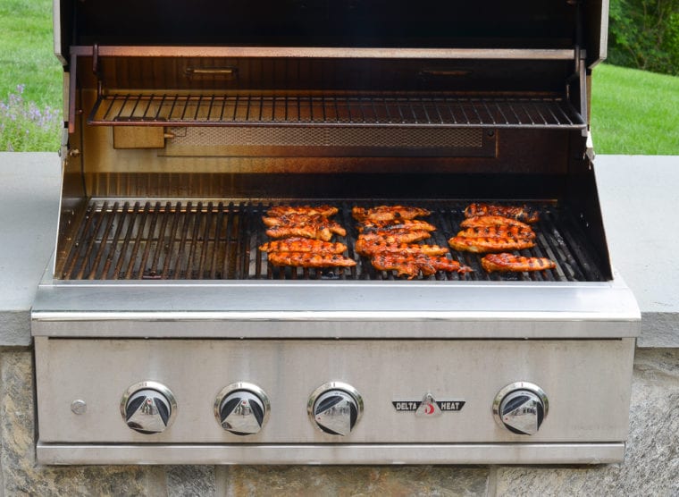 chicken on grill with BBQ sauce