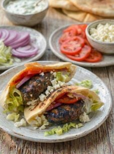 Lamb burgers on a plate with all the fixings.