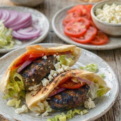 Lamb burgers on a plate with all the fixings.