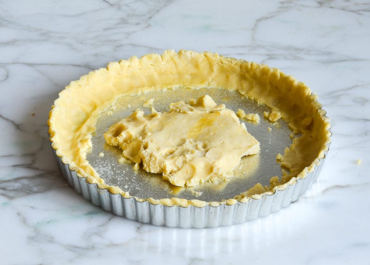 pressing pate sucree into tart pan