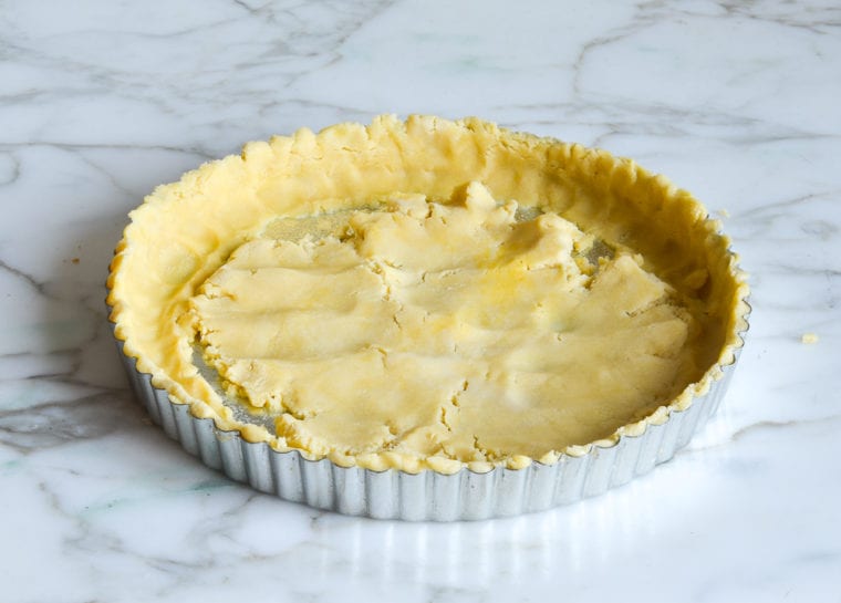 pressing pate sucree into tart pan