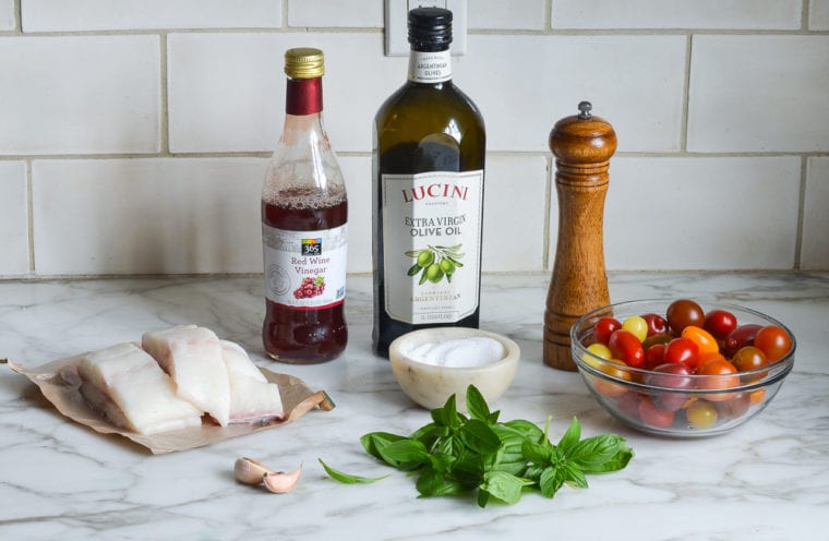Halibut ingredients including tomatoes, red wine vinegar, and olive oil.