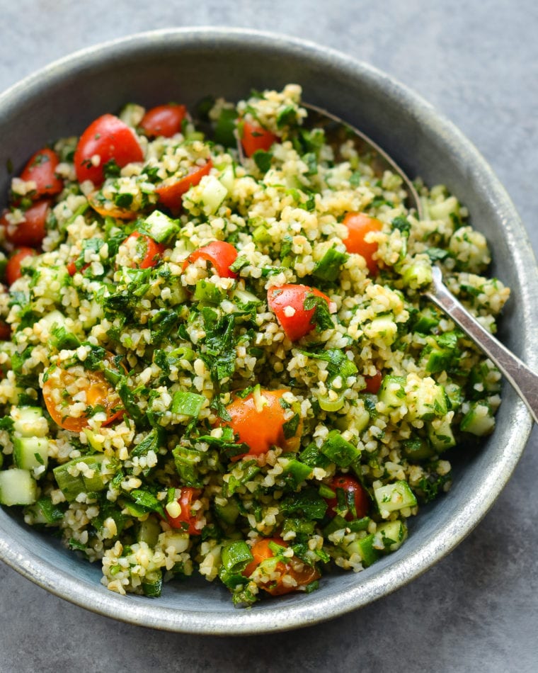 Spoon in a bowl of tabbouleh.