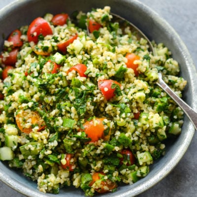 Spoon in a bowl of tabbouleh.