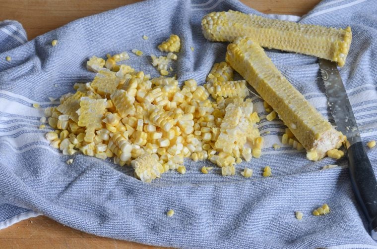 cutting corn kernels off the cob