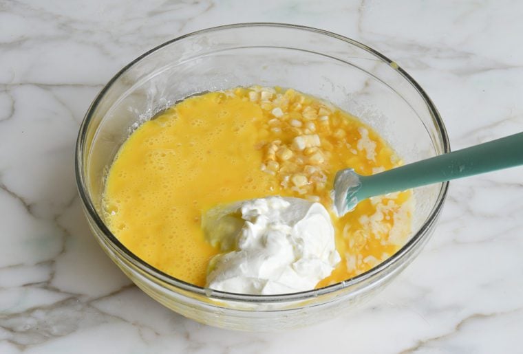 adding sour cream and beaten eggs