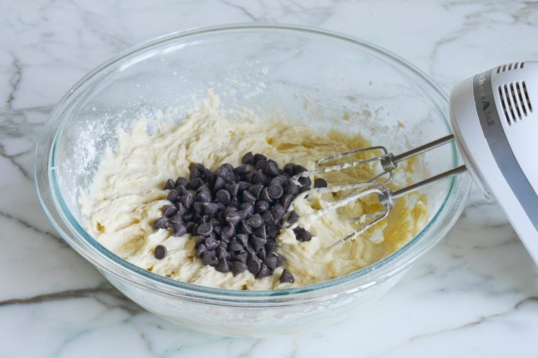 adding chocolate chips to batter