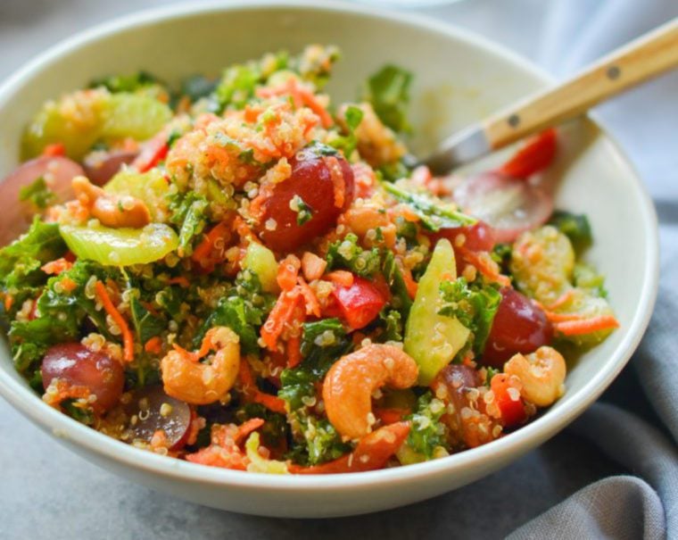 Bowl of autumn kale and quinoa salad with chutney dressing.
