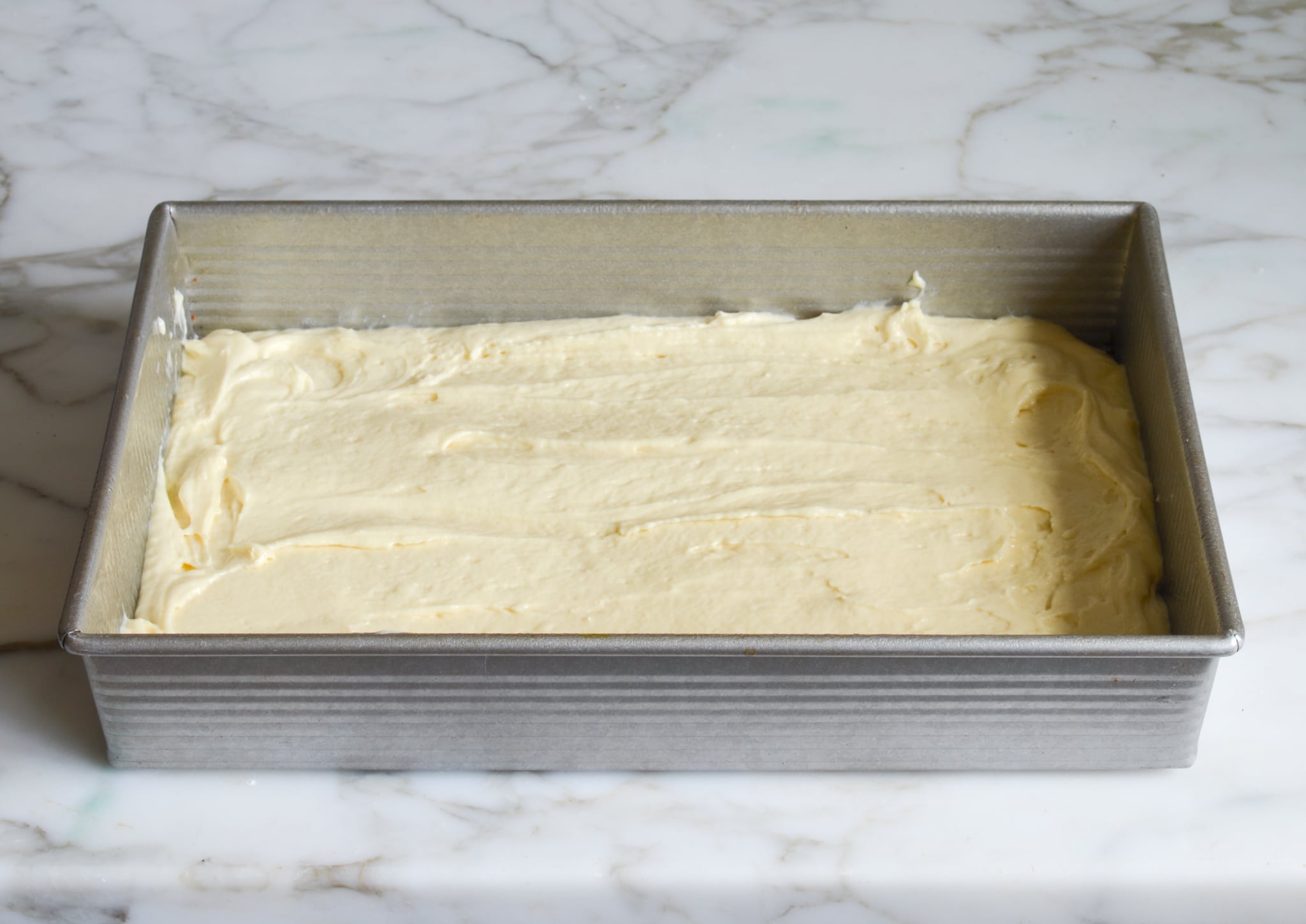 Spreading the batter in the cake pan.