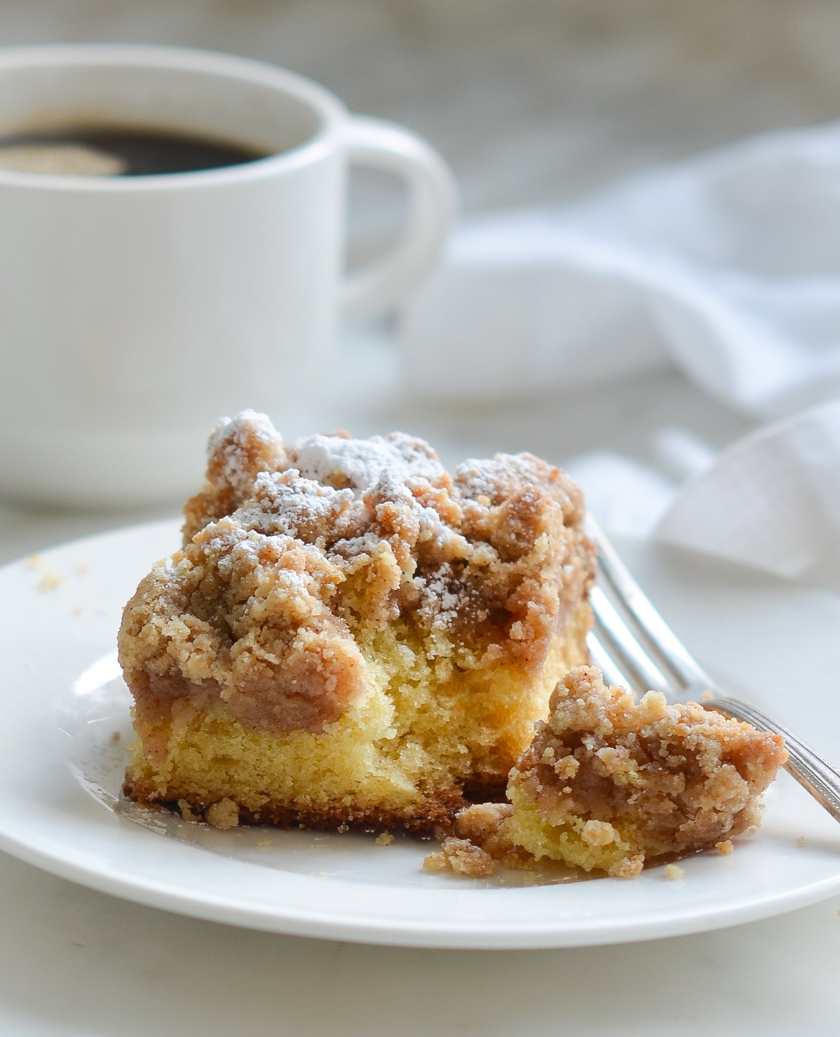 Piece of crumb cake on a plate.