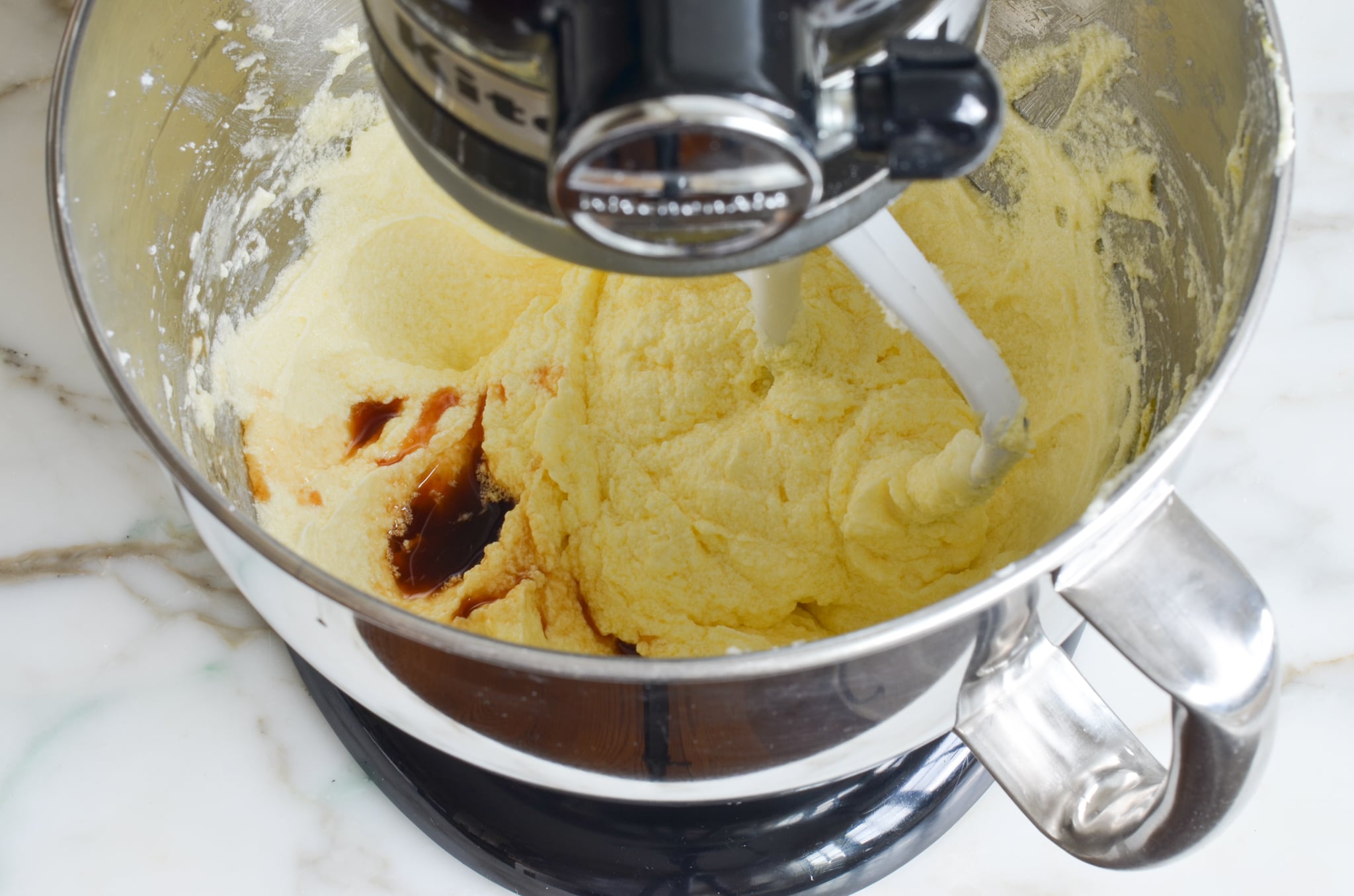Mixing in the vanilla into the cake batter.