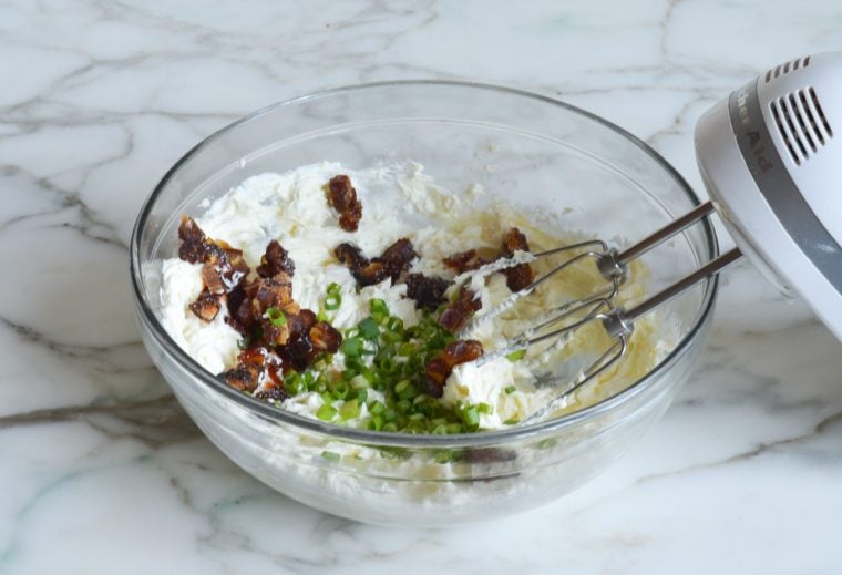 adding scallions and dates to cheese and butter mixture