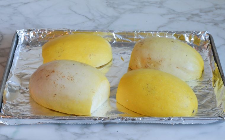 spaghetti squash cut side down on baking sheet