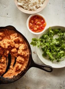 Mostly-served skillet of butter chicken.