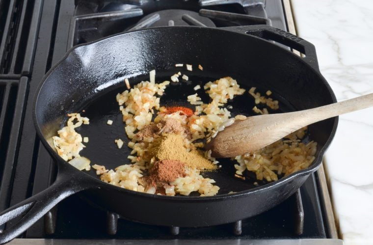 adding spices to ginger and onion mixture
