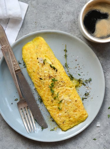 Omelet on a plate with silverware.