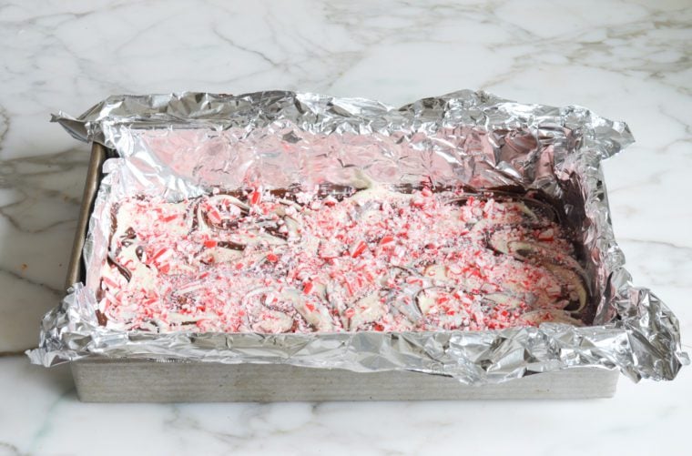 sprinkling the candy cane pieces over the swirled chocolates