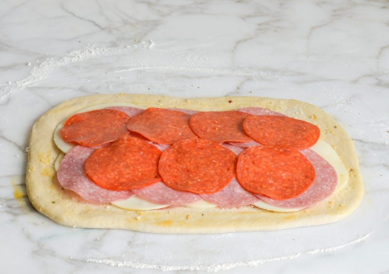 layering meat and cheese