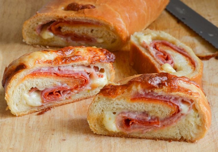 Slices of stromboli on a cutting board.