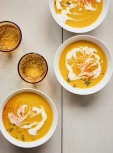Bowls of pumpkin soup on a table.