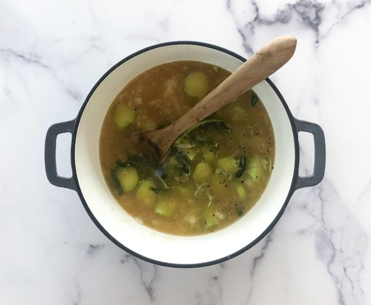 adding broccoli stems, salt, pepper, broth and water