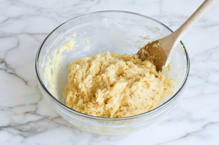 Wooden spoon in a bowl of finished dough.