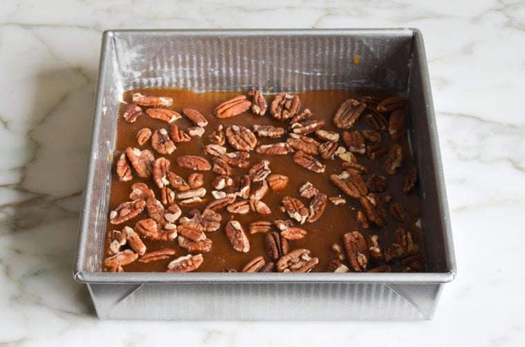 caramel and whole pecans in cake pan