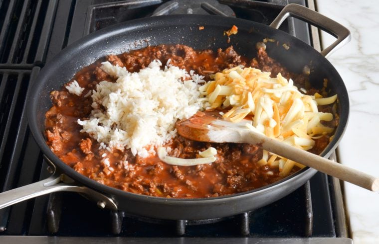 adding rice and cheese