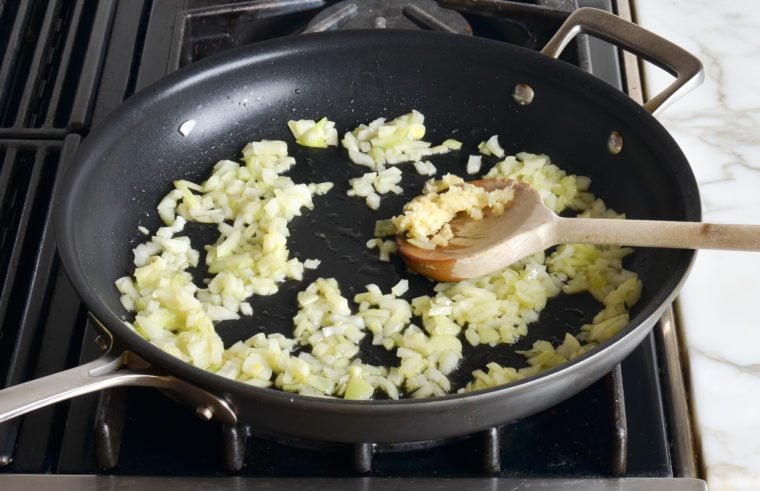 adding garlic to skillet