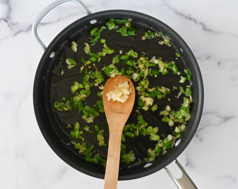 adding the garlic to the skillet
