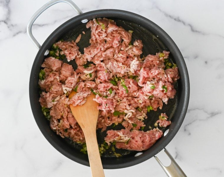 raw pork in skillet