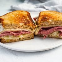 reuben sandwich on plate with pickle