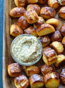 baking sheet with pretzel bites and bowl of dip