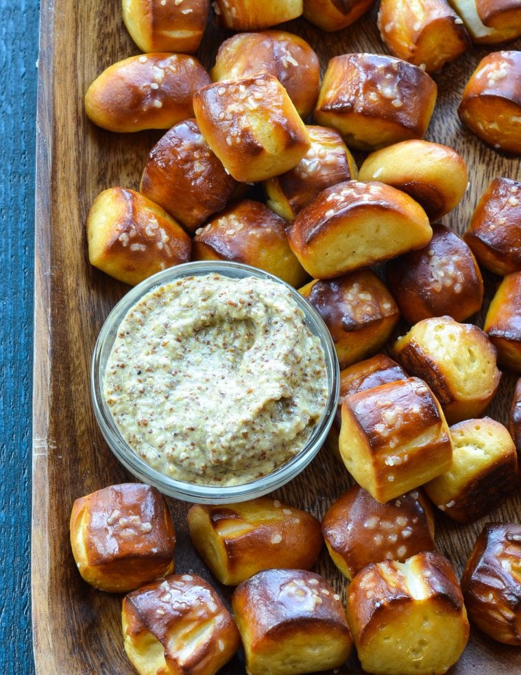 baking sheet with pretzel bites and bowl of dip