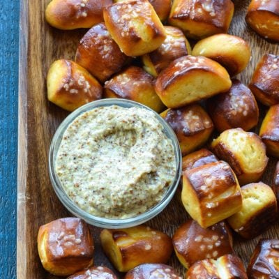 baking sheet with pretzel bites and bowl of dip