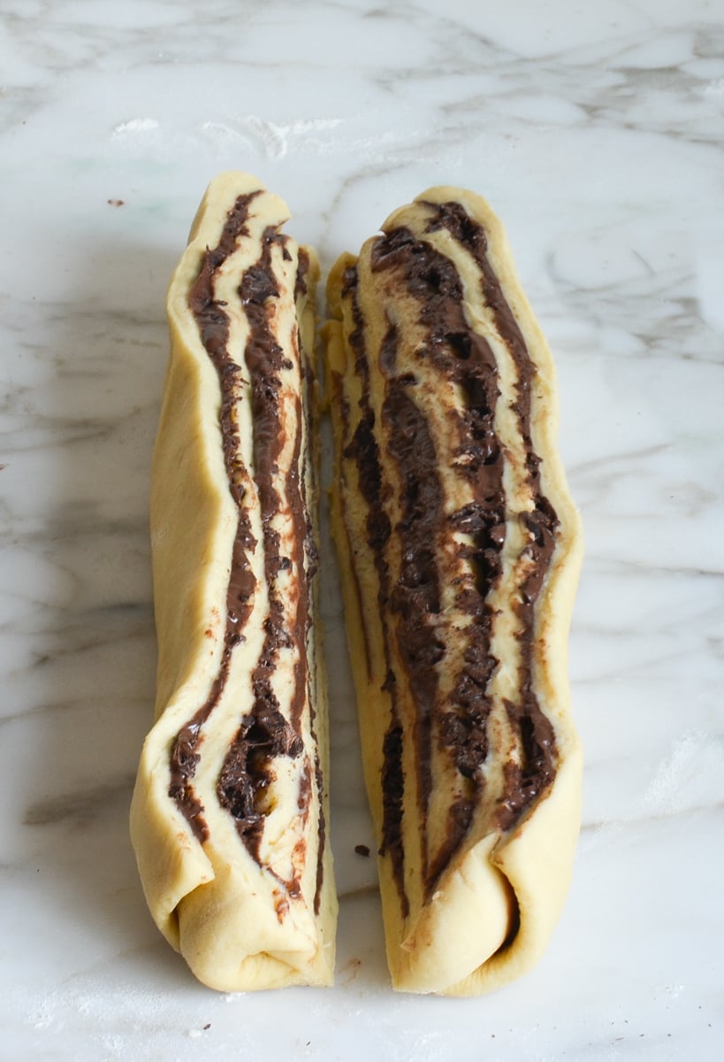babka dough sliced in half on marble.