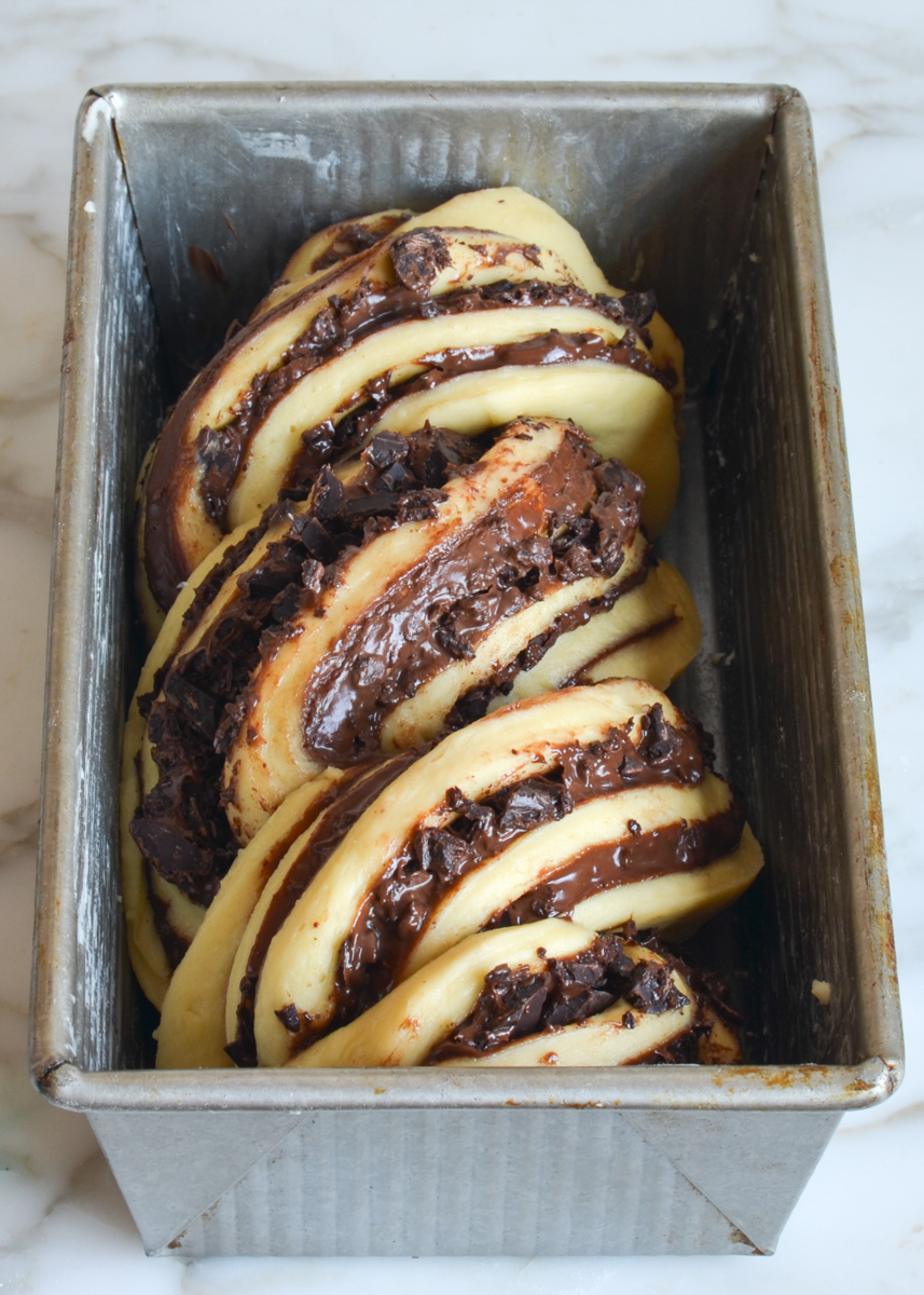 twisted babka dough in loaf pan.